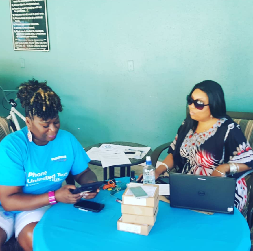 Premier assisting a community member at an outreach event