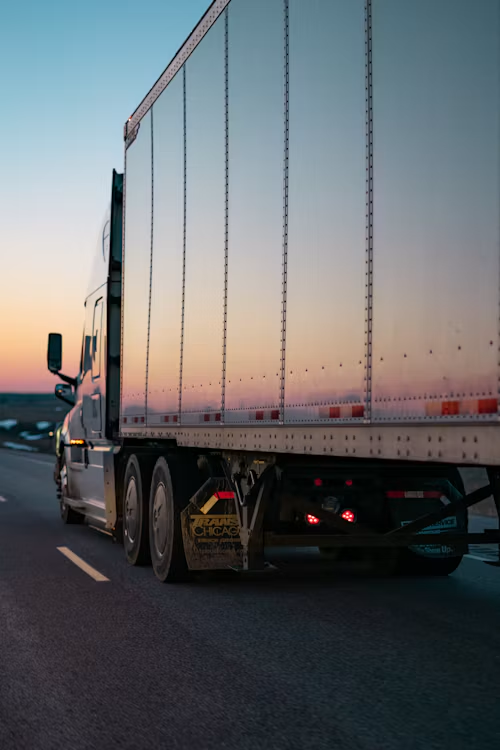 Freight truck traveling at sunset